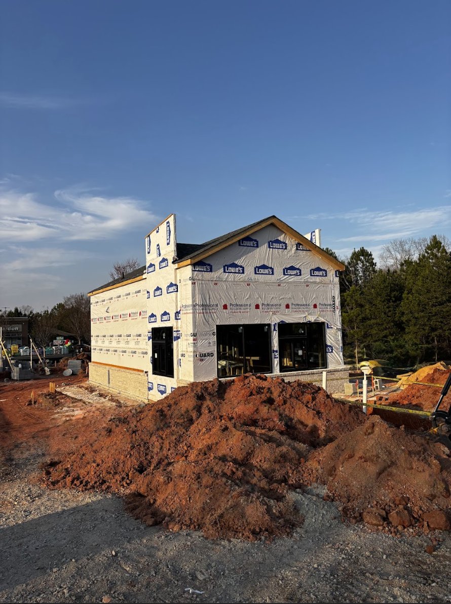 Ellianos Coffee Mooresville mid-construction with framing and weather barrier